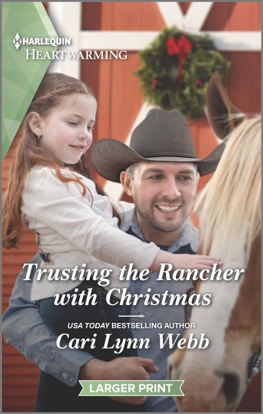 Trusting the rancher with Christmas / Cari Lynn Webb.